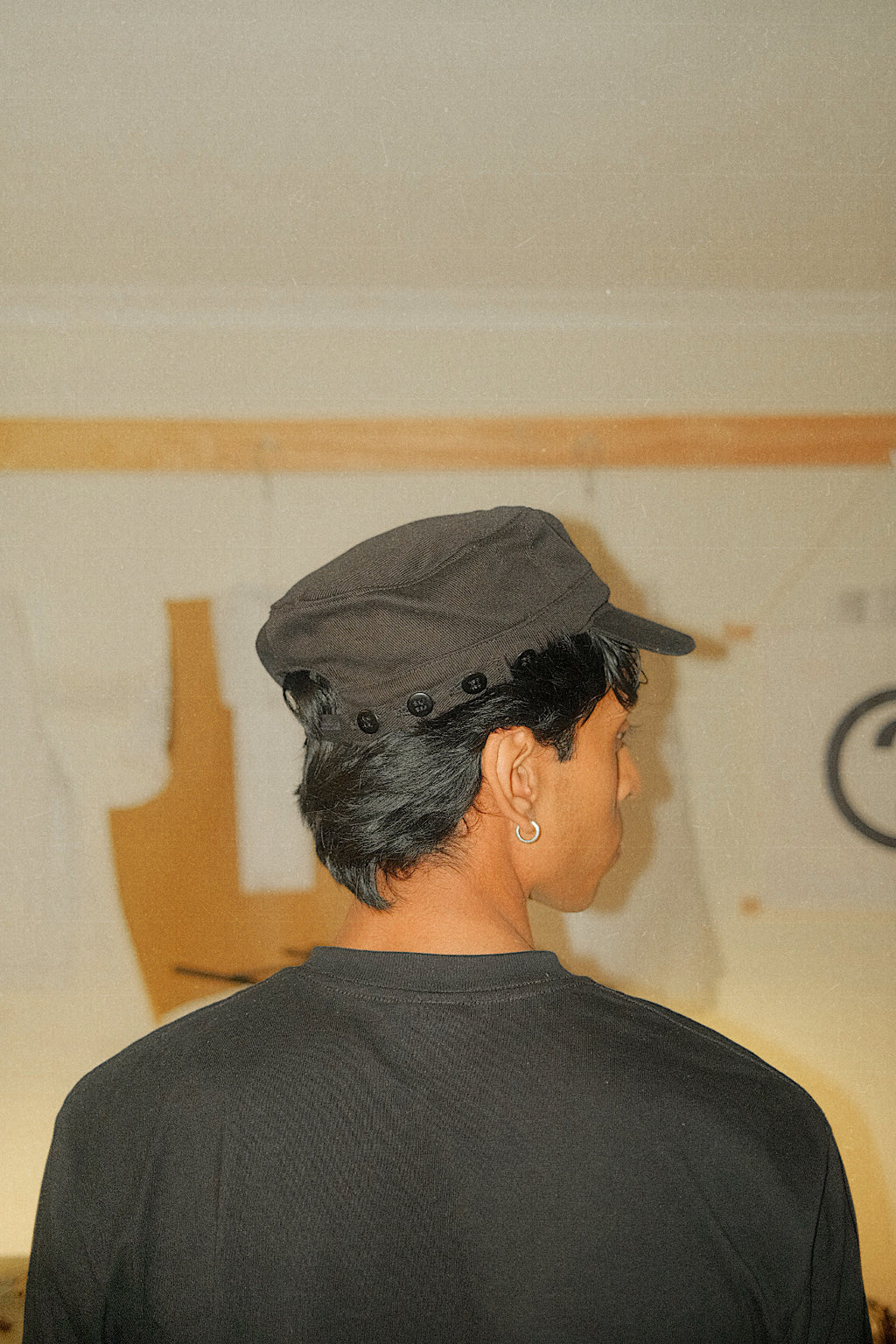 Back/side profile of Button Hat showcasing the button closure