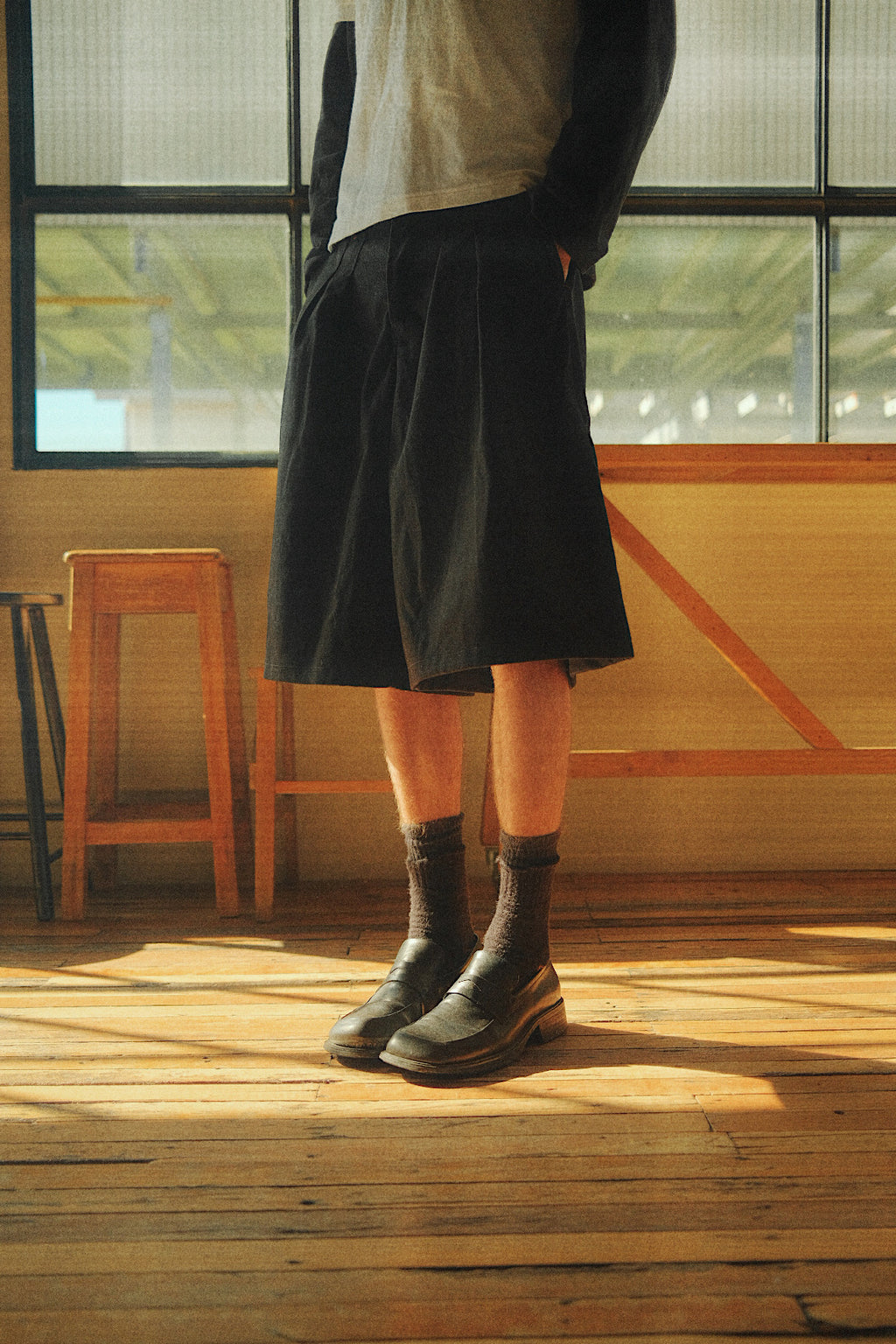 Close up of College Pleated Short showcasing the wide, long fit