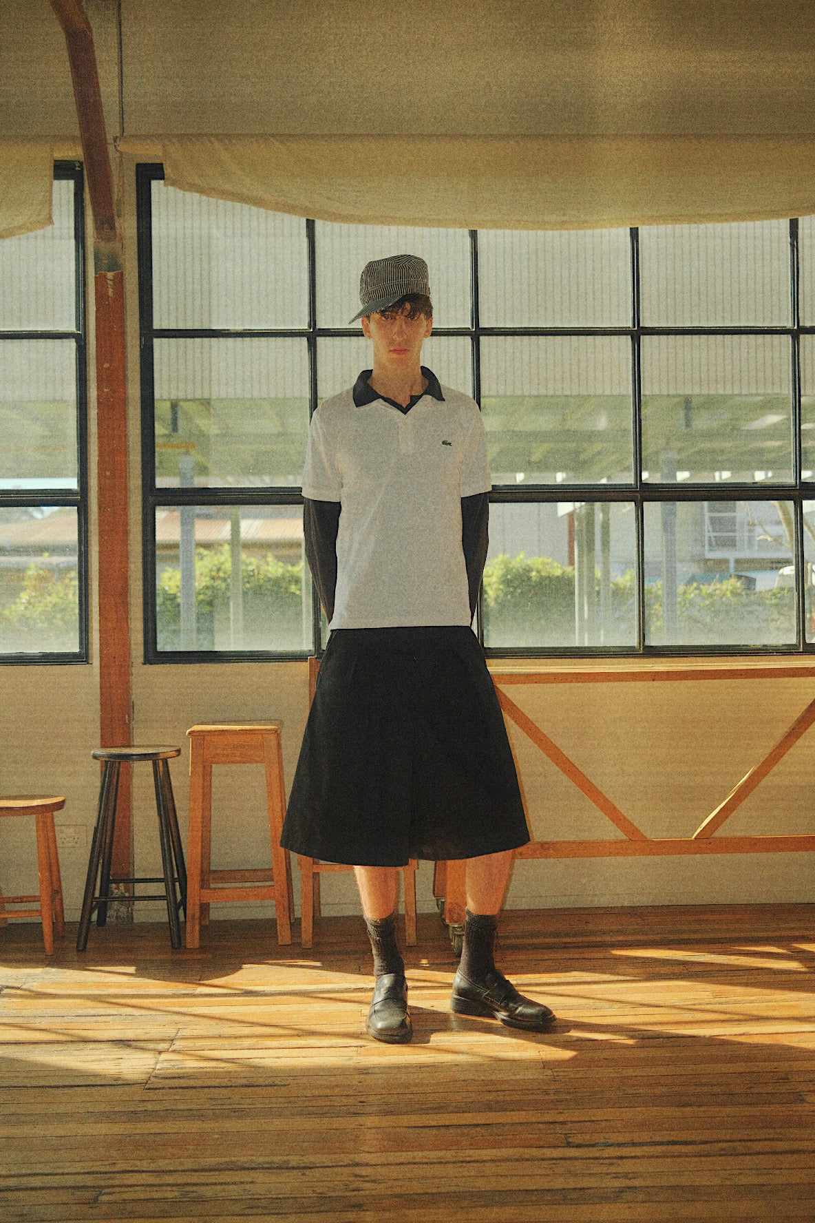 Connor styled in our College Pleated Short