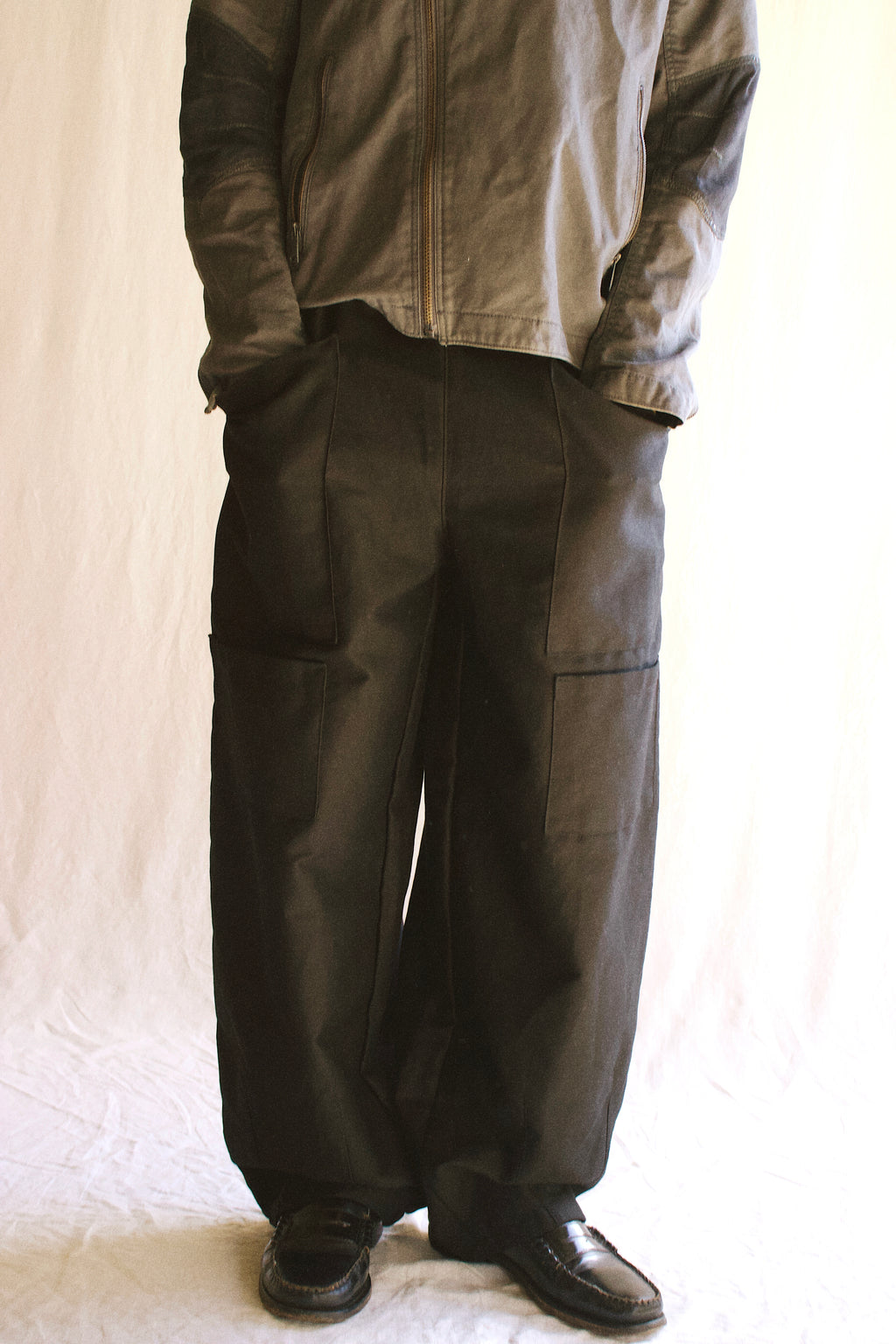 Our studio pants worn on body, showing details such as the four patch pockets and balloon fit.